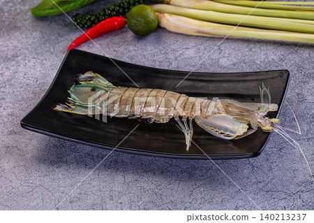 fresh raw mantis shrimp on black plate with cooking ingredients fresh raw mantis shrimp on black plate with cooking ingredients 140213237