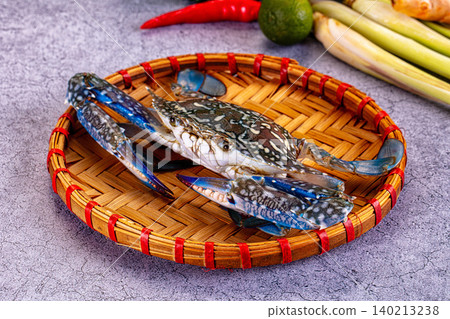 Raw blue crab on woven bamboo tray with asian ingredients Raw blue crab on woven bamboo tray with asian ingredients 140213238