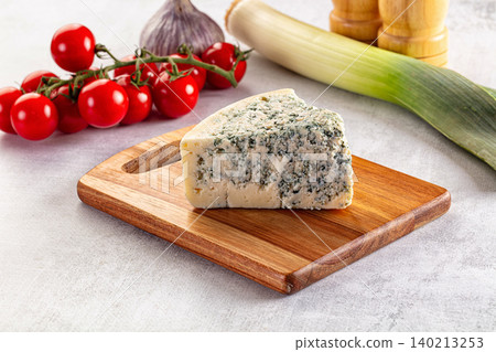 Blue cheese piece on wooden board with fresh vegetables Blue cheese piece on wooden board with fresh vegetables 140213253