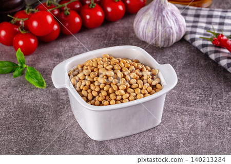 Raw soya beans in white ceramic bowl with fresh vegetables Raw soya beans in white ceramic bowl with fresh vegetables 140213284