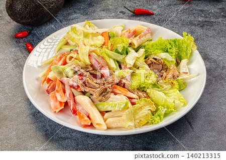 Pasta salad with tuna, lettuce, and crab sticks on white plate Pasta salad with tuna, lettuce, and crab sticks on white plate 140213315