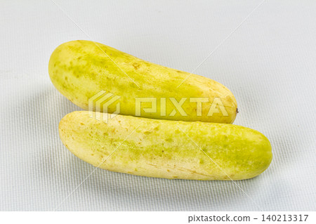 Two whole ripe white cucumbers on textured white background Two whole ripe white cucumbers on textured white background 140213317