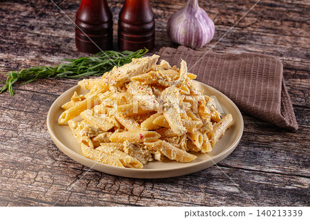 Creamy chicken Alfredo pasta on rustic wooden table Creamy chicken Alfredo pasta on rustic wooden table 140213339