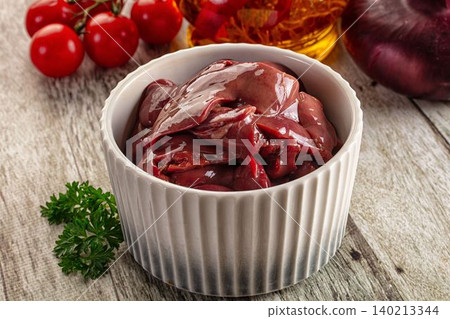 Raw chicken liver in white bowl with fresh ingredients Raw chicken liver in white bowl with fresh ingredients 140213344