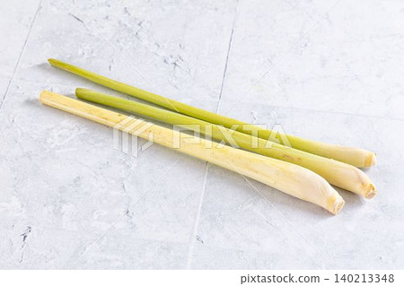 Fresh lemongrass stalks on light gray stone background Fresh lemongrass stalks on light gray stone background 140213348