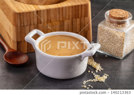 Asian sesame sauce with seeds in white bowl 140213363