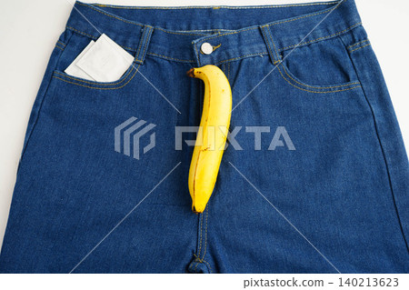 Banana with measuring tape on jean trousers, penis health. Banana with measuring tape on jean trousers, penis health. 140213623