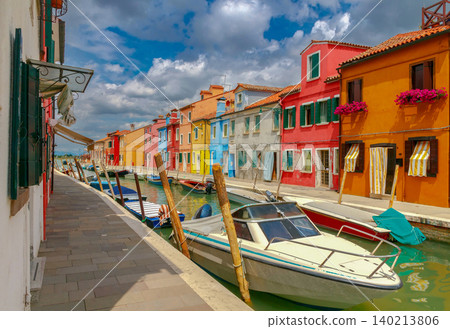 Colorful canal houses and boats on Burano Island in Venice Italy 140213806