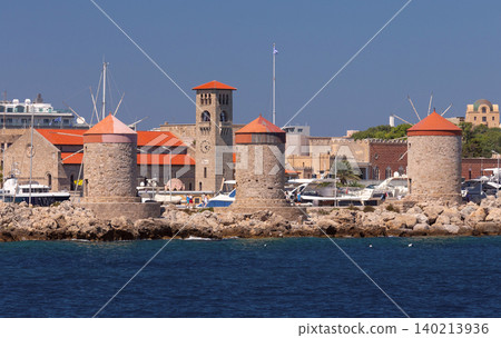 Windmills and harbor skyline in Rhodes Town on sunny clear summer day Windmills and harbor skyline in Rhodes Town on sunny clear summer day 140213936