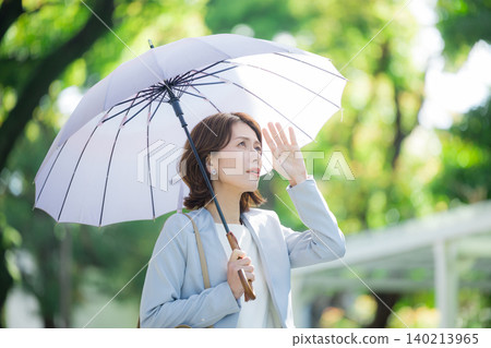 Business woman pointing a parasol 140213965