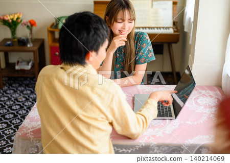 Two people talking on a laptop Two people talking on a laptop 140214069