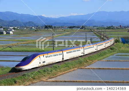 E8 series Yamagata Shinkansen running through a rural landscape 140214369