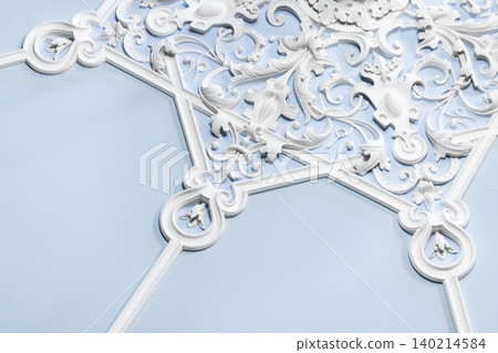 Sculptural plaster molding featuring intricate white designs Sculptural plaster molding featuring intricate white designs 140214584