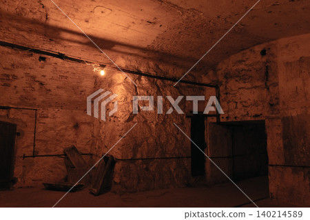 Dim underground cellar with rough stone walls Dim underground cellar with rough stone walls 140214589