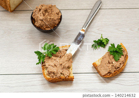 Fresh bread with creamy pate and parsley garnish 140214632