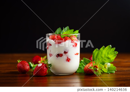 Fresh strawberry yogurt dessert with green basil leaves Fresh strawberry yogurt dessert with green basil leaves 140214636