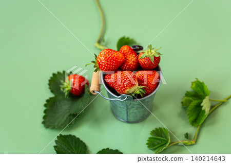 Sweet red strawberries and foliage on mint background Sweet red strawberries and foliage on mint background 140214643