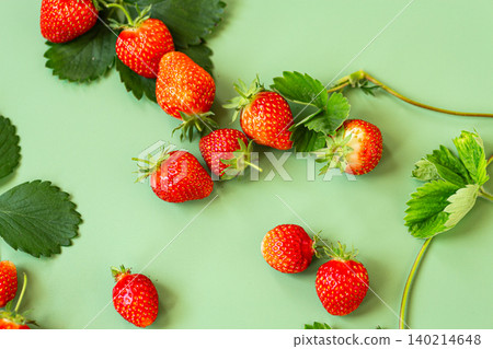 Organic garden strawberries arranged on pastel green backdrop Organic garden strawberries arranged on pastel green backdrop 140214648
