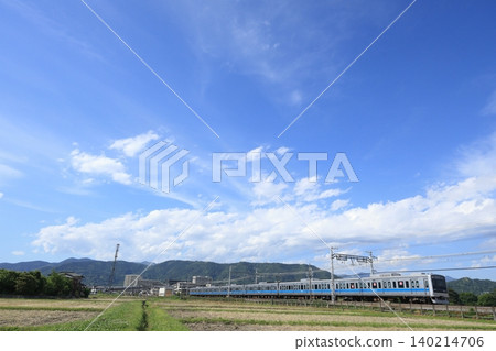 The Odakyu Line runs under a blue sky. 140214706