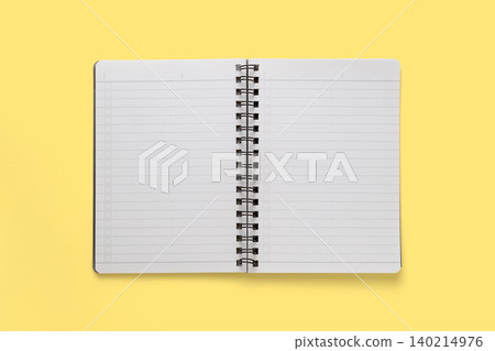 A photograph of a double-page spread notepad taken against a yellow background, viewed from directly above. A photograph of a double-page spread notepad taken against a yellow background, viewed from directly above. 140214976
