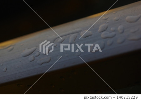 Raindrops on the handrail (from bottom left to top right) 140215229