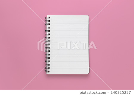 A photograph of a ring binder notebook taken from directly above, with a pink background. A photograph of a ring binder notebook taken from directly above, with a pink background. 140215237