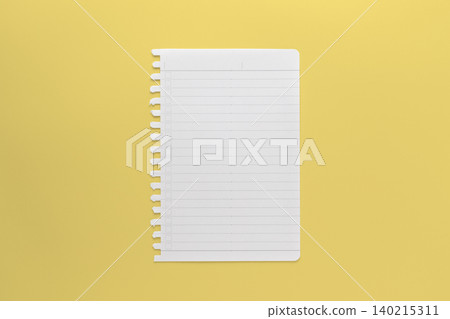 A photograph of a notepad page taken from directly above, against a yellow background. A photograph of a notepad page taken from directly above, against a yellow background. 140215311