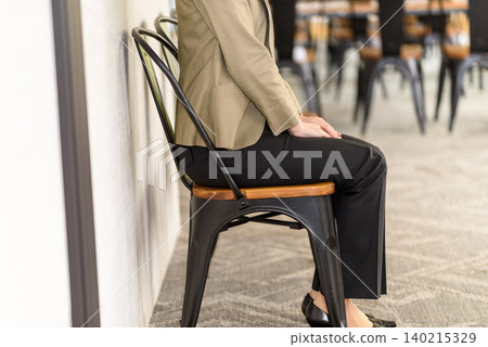 Profile of a woman sitting in a chair Profile of a woman sitting in a chair 140215329