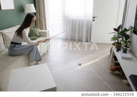 Happy woman with cat playing and having fun at home Happy woman with cat playing and having fun at home 140215559