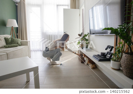 Young woman with cat playing and having fun at home Young woman with cat playing and having fun at home 140215562