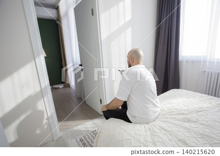 Man sitting with smartphone and using online mobile app and social media Man sitting with smartphone and using online mobile app and social media 140215620