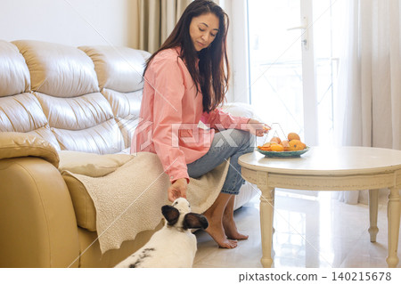 Portrait of woman with domestic bunny pet at home 140215678