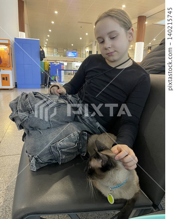 Cute Child Girl with Cat sitting in Airport Travel Terminal. Pet Travel 140215745