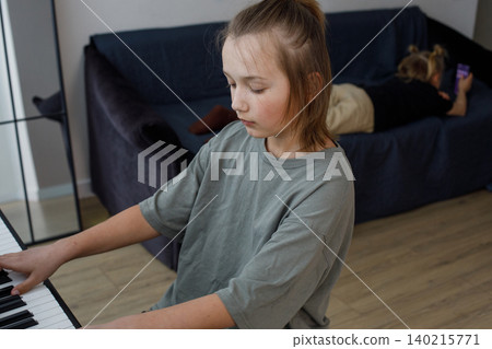 Attractive teen boy enjoy playing practicing electronic piano keyboard Attractive teen boy enjoy playing practicing electronic piano keyboard 140215771