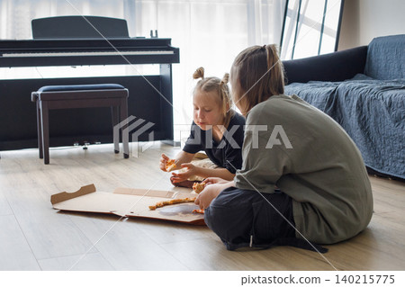 Pretty kids sibling eating pizza at home. Little girl and boy children portrait 140215775