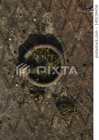Rusty Metal Ring on Old Manhole Cover Texture Closeup Rusty Metal Ring on Old Manhole Cover Texture Closeup 140216456