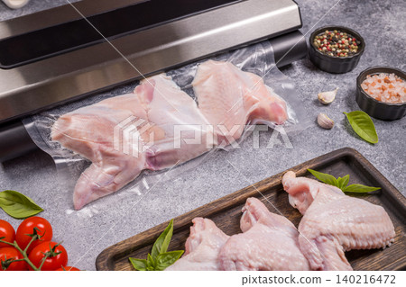 Vacuum sealing raw chicken wings for food preservation Vacuum sealing raw chicken wings for food preservation 140216472
