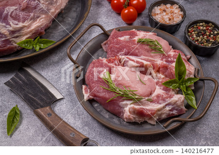 Raw pork steak cuts preparing with herbs and spices Raw pork steak cuts preparing with herbs and spices 140216477