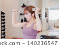 A young woman doing dumbbell training at the gym 140216547