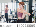 Young woman stretching in the gym 140216605