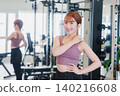 Young woman stretching in the gym 140216608