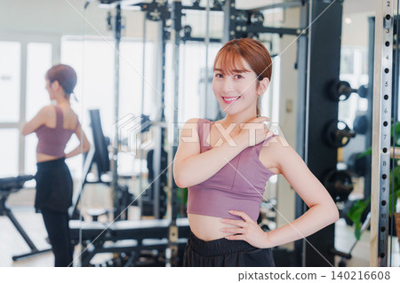 Young woman stretching in the gym 140216608