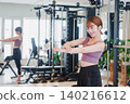 Young woman stretching in the gym 140216612