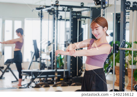 Young woman stretching in the gym 140216612