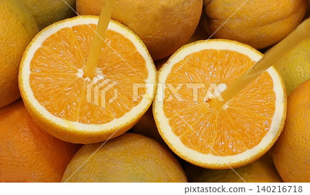 Close-up of freshly cut oranges with drinking straws in fruits, highlighting freshness, natural citrus flavor, healthy nutrition, and vibrant color. Close-up of freshly cut oranges with drinking straws in fruits, highlighting freshness, natural citrus flavor, healthy nutrition, and vibrant color. 140216718