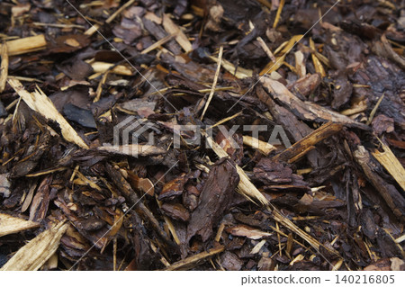 Wet Wood Chips and Brown Bark Mulch Texture Closeup Wet Wood Chips and Brown Bark Mulch Texture Closeup 140216805