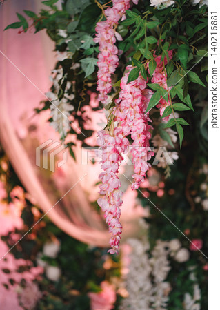Vertical shot of hanging wedding decoration with pink wisteria and white flowers Vertical shot of hanging wedding decoration with pink wisteria and white flowers 140216881
