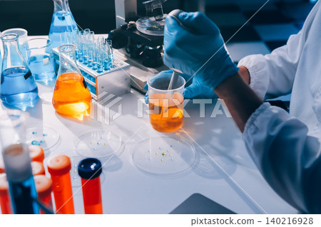 Lab technician experimenting in lab Lab technician experimenting in lab 140216928