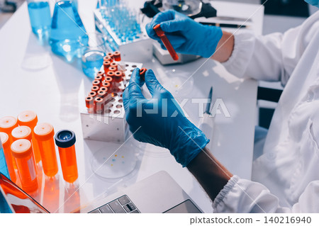 Lab technician experimenting in lab 140216940