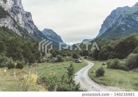 Scenic mountain valley road in Prokletije National Park, Montenegro landscape Scenic mountain valley road in Prokletije National Park, Montenegro landscape 140216981